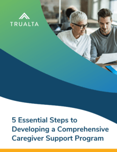 Two professionals reviewing documents together in an office setting with a Trualta logo and title about a comprehensive caregiver support program.