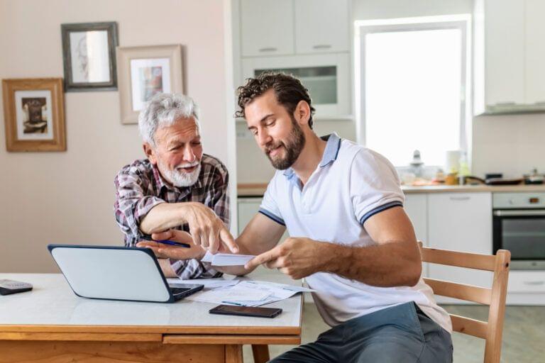 A father and son looking over paperwork
