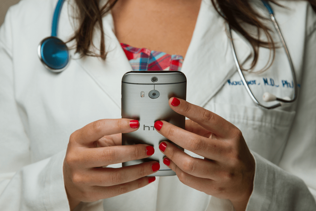 close up of female doctor holder a phone