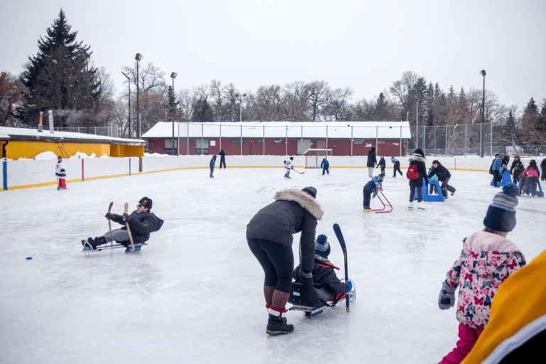 People engaging in various ice sports activities on an outdoor rink in winter, covered by Trualta press releases.