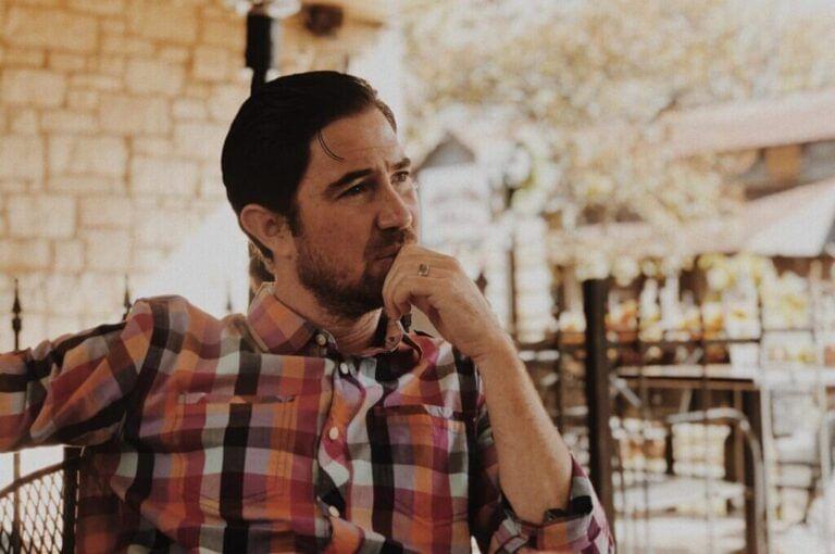 Man thinking in living room.