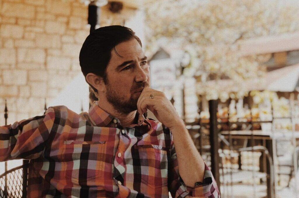 Man thinking in living room.