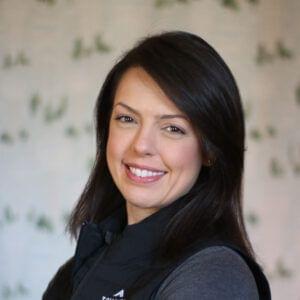 A smiling woman with brown hair against a careers patterned background.