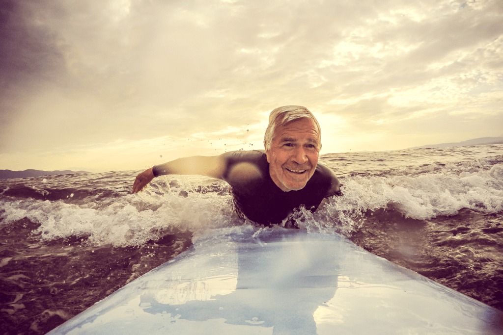 older man surfing to illustrate the silver tsunami