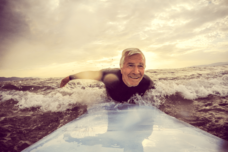 older man surfing to illustrate the silver tsunami