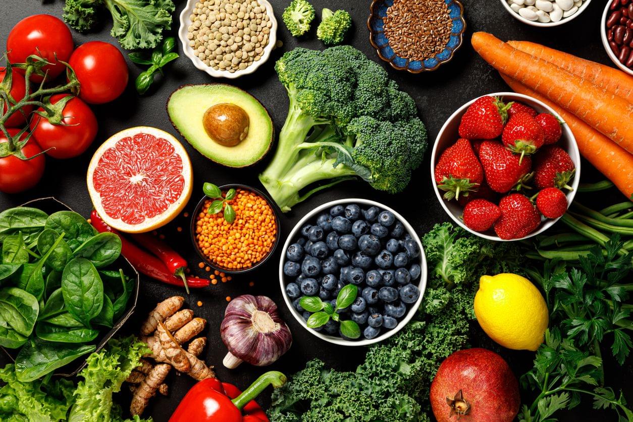 a variety of fruits and vegetables sitting on a table